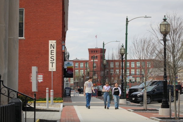 Three people walking in downtown Brunswick