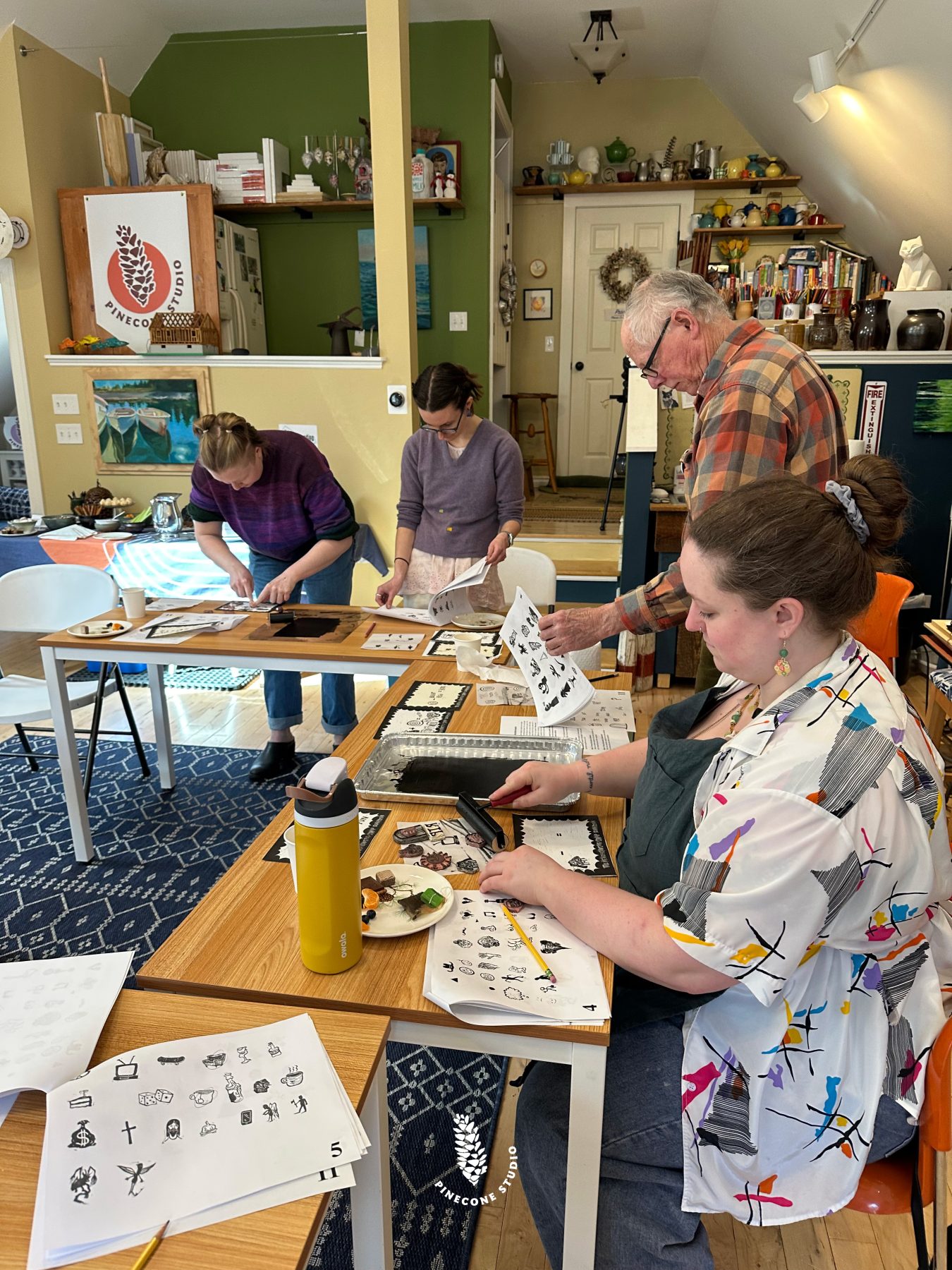 Group of people making linocut prints