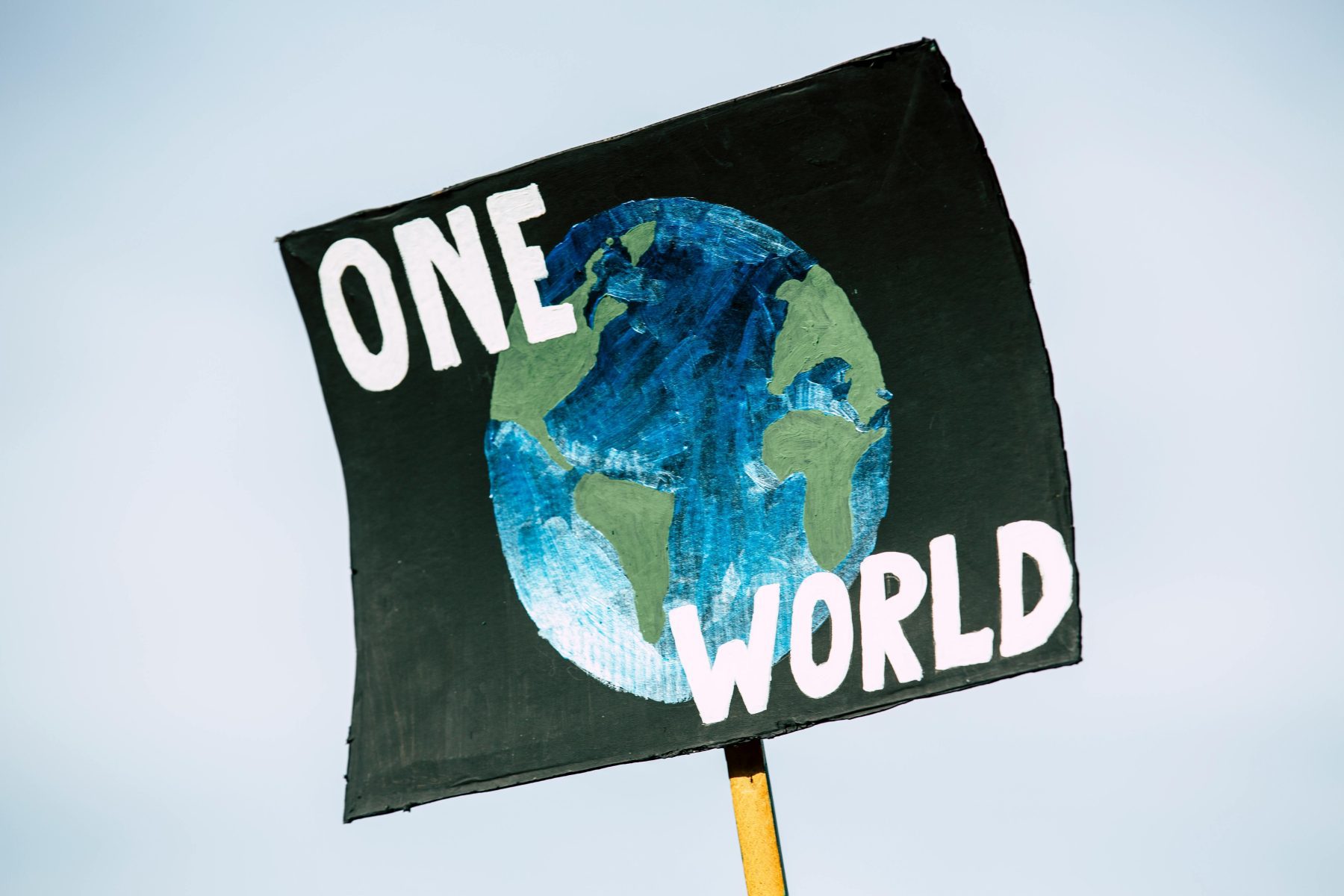 Earth Day sign reading "one world"